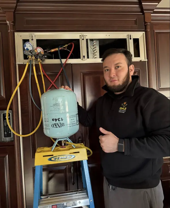 QAZ Appliance Services technician recharging a built-in refrigerator